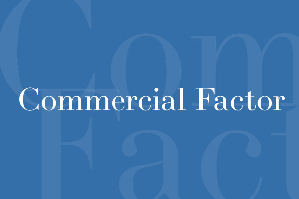 Blue graphic with the words ‘Commercial Factor’ in white serif font centered on the image. The background features large, faint letters forming the words ‘Commercial Factor’ in a lighter blue overlay, creating a professional, finance-industry look.